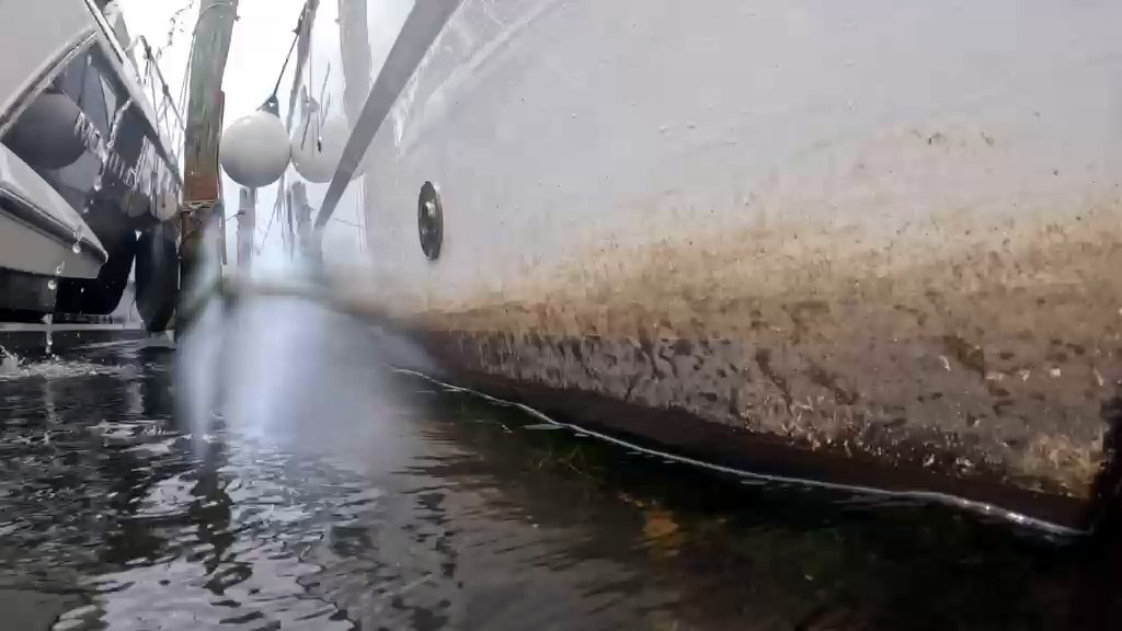 Brown growth stain along a white hull at the waterline